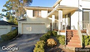 A detached two-storey home with a double garage, front steps and a landscaped entrance. 197B Midson Road, Epping, NSW.